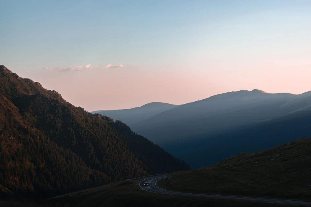 Layered hills fading into a soft dusk sky