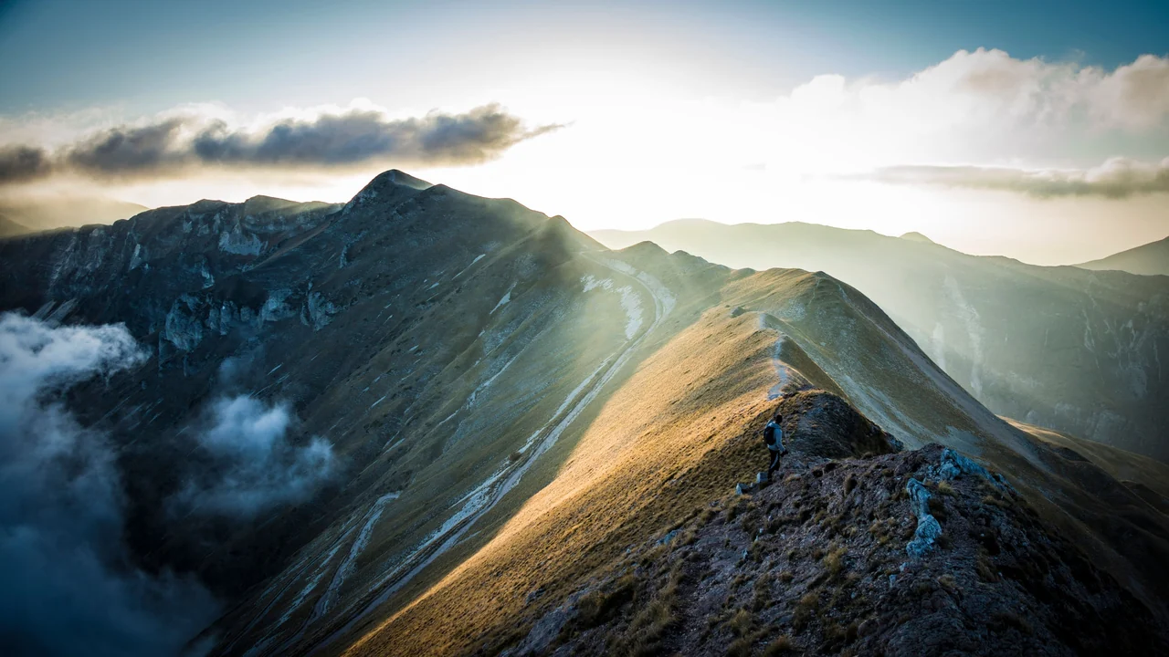 Sunlight pouring over a mountain ridge